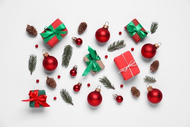 Flat lay composition with gift boxes and Christmas decor on white background