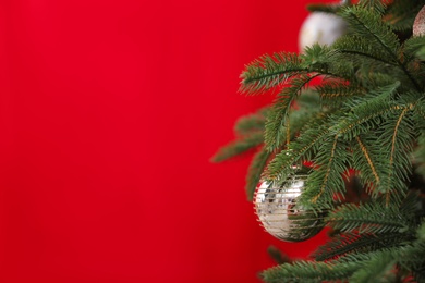 Photo of Beautifully decorated Christmas tree against color background, closeup