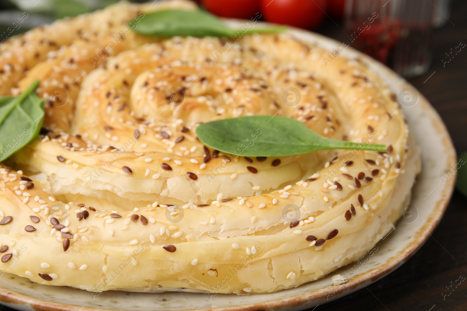 Photo of Delicious puff pastry with spinach on table, closeup