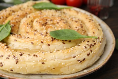 Photo of Delicious puff pastry with spinach on table, closeup