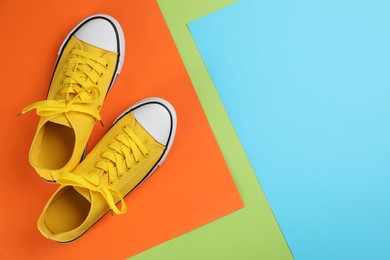 Photo of Stylish sneakers on color background, flat lay. Space for text