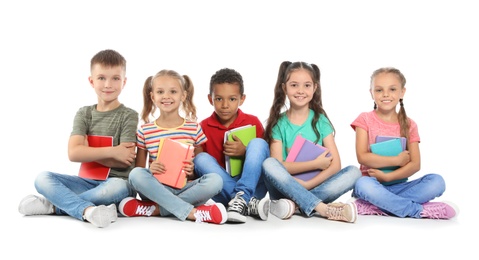 Group of little children with school supplies on white background