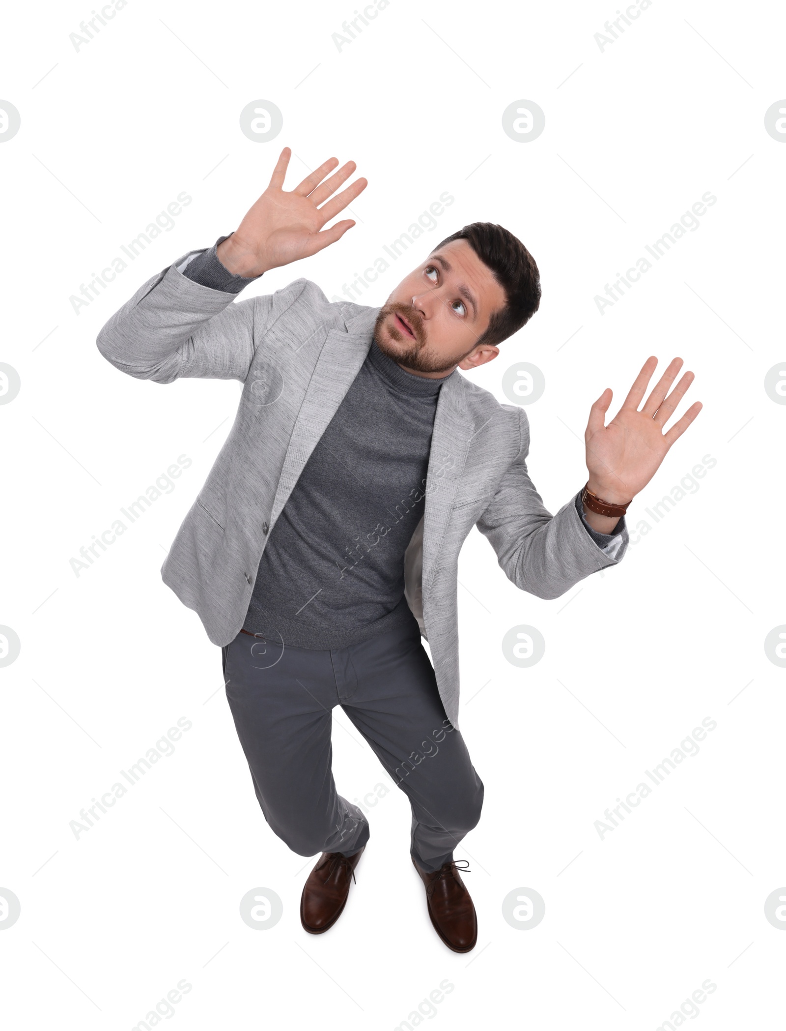 Photo of Handsome bearded businessman in suit evading something on white background, above view