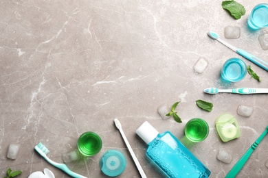 Flat lay composition with oral care products and space for text on marble background. Teeth hygiene