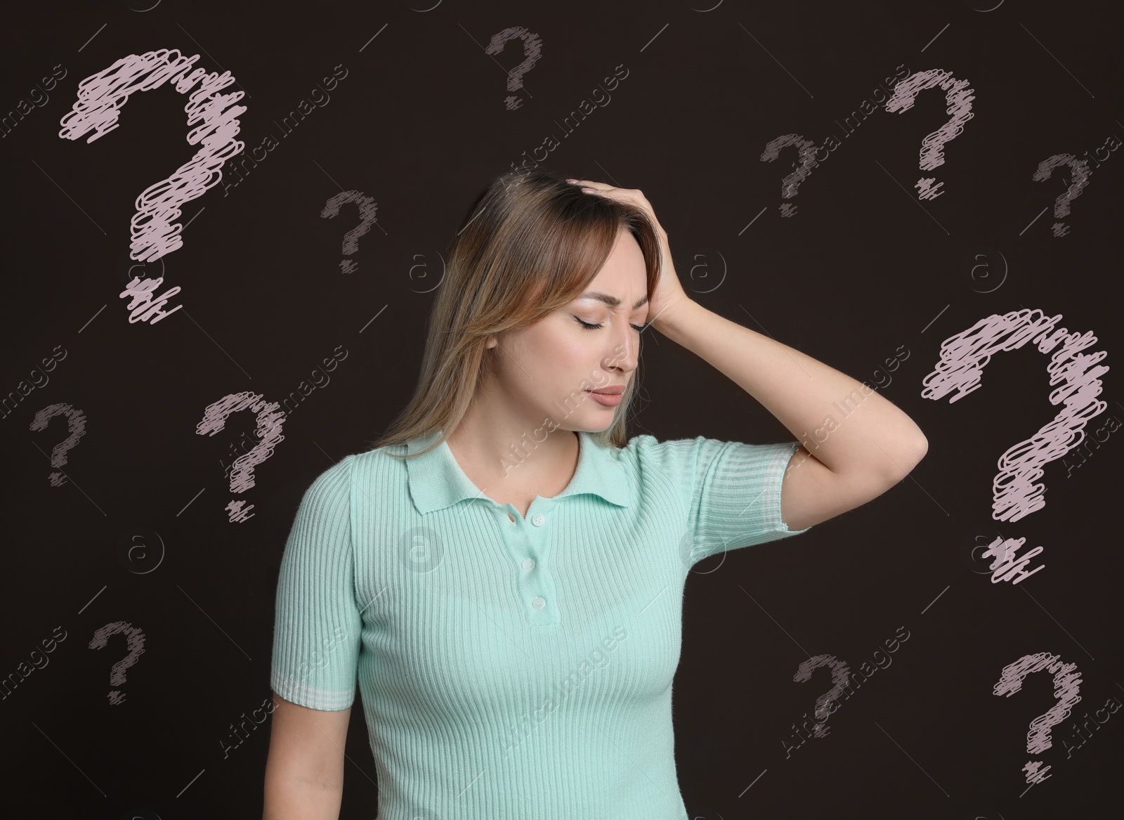 Image of Amnesia. Confused young woman and question marks on brown background