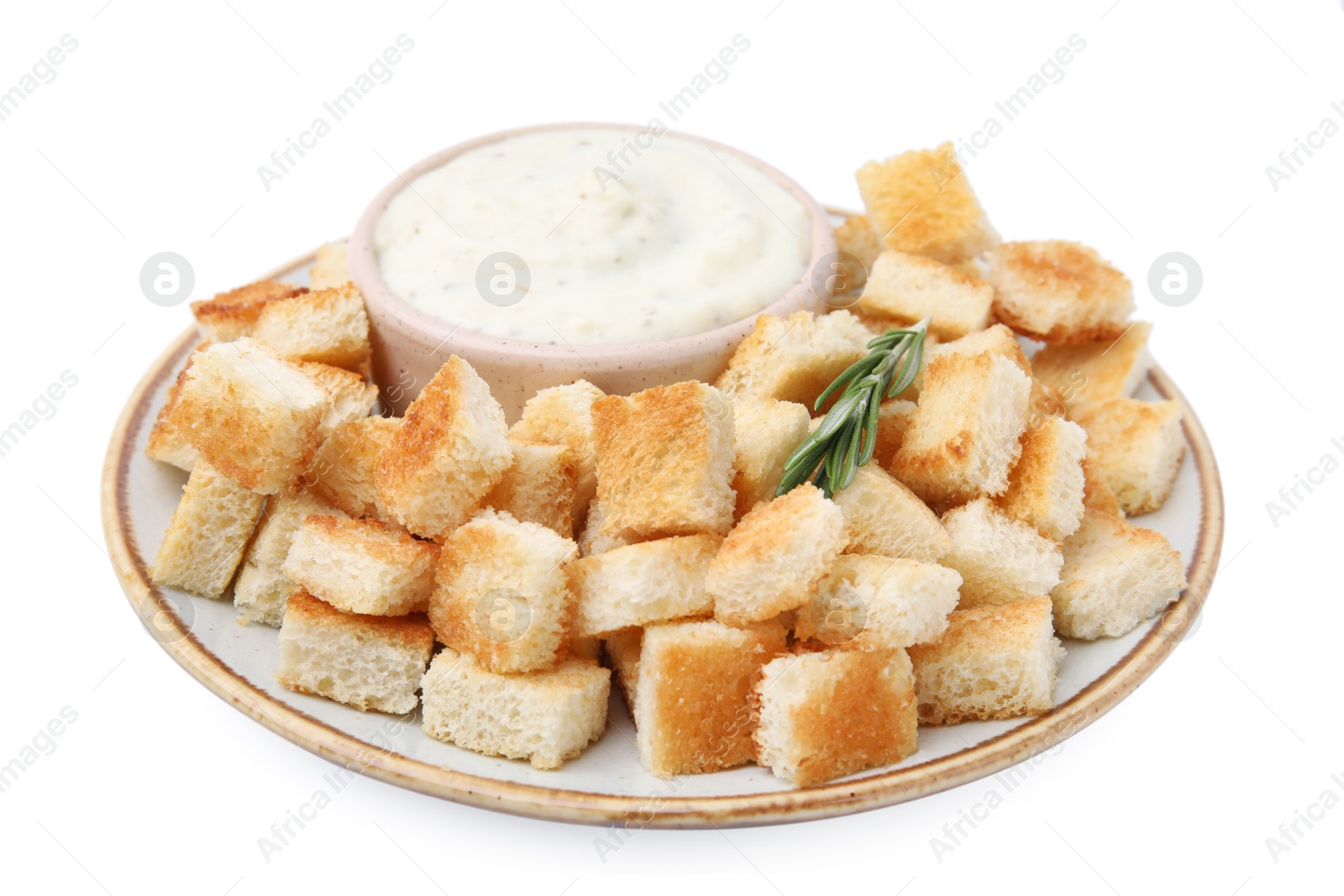 Photo of Delicious crispy croutons with rosemary and sauce on white background