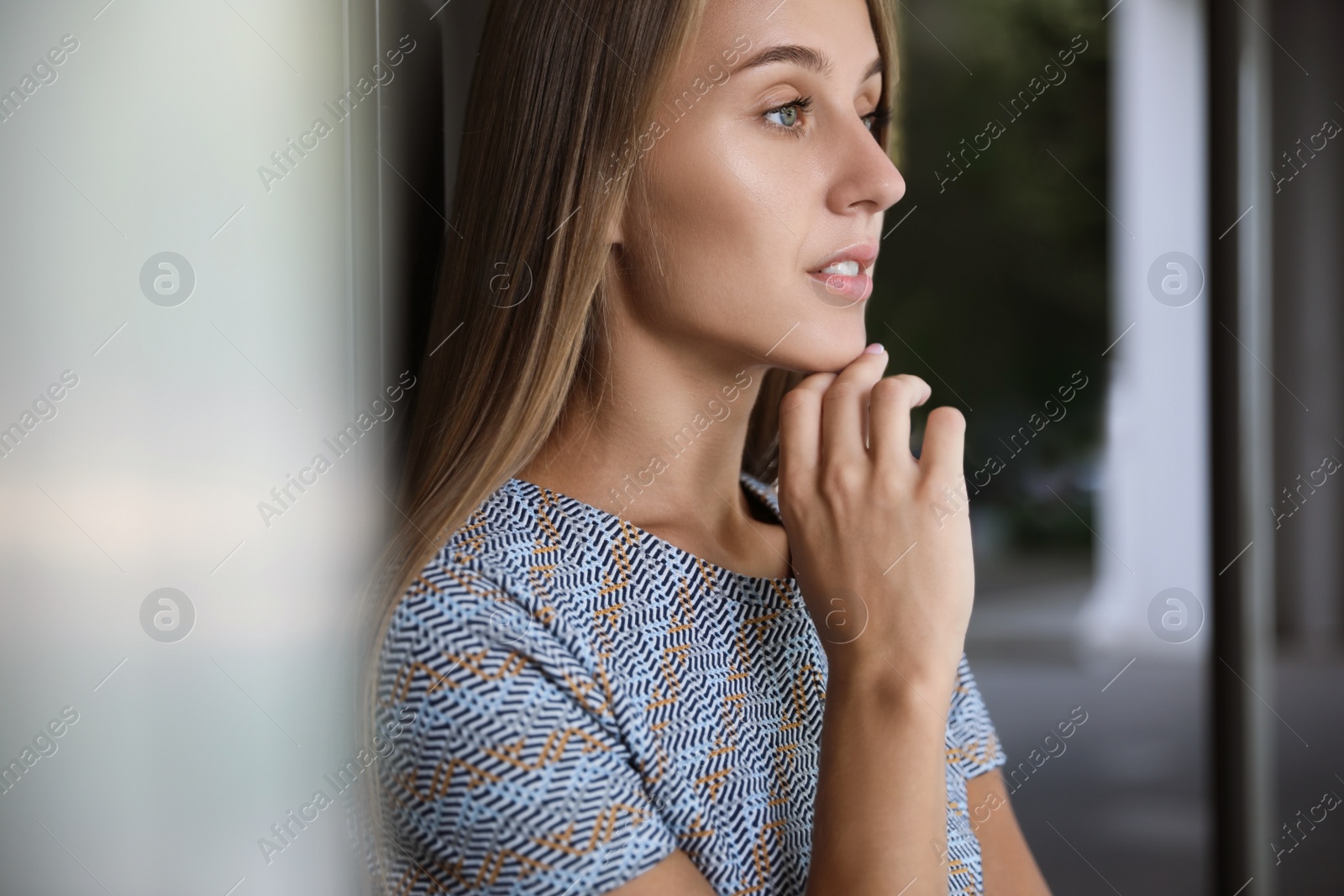 Photo of Beautiful young woman in stylish t-shirt indoors, closeup