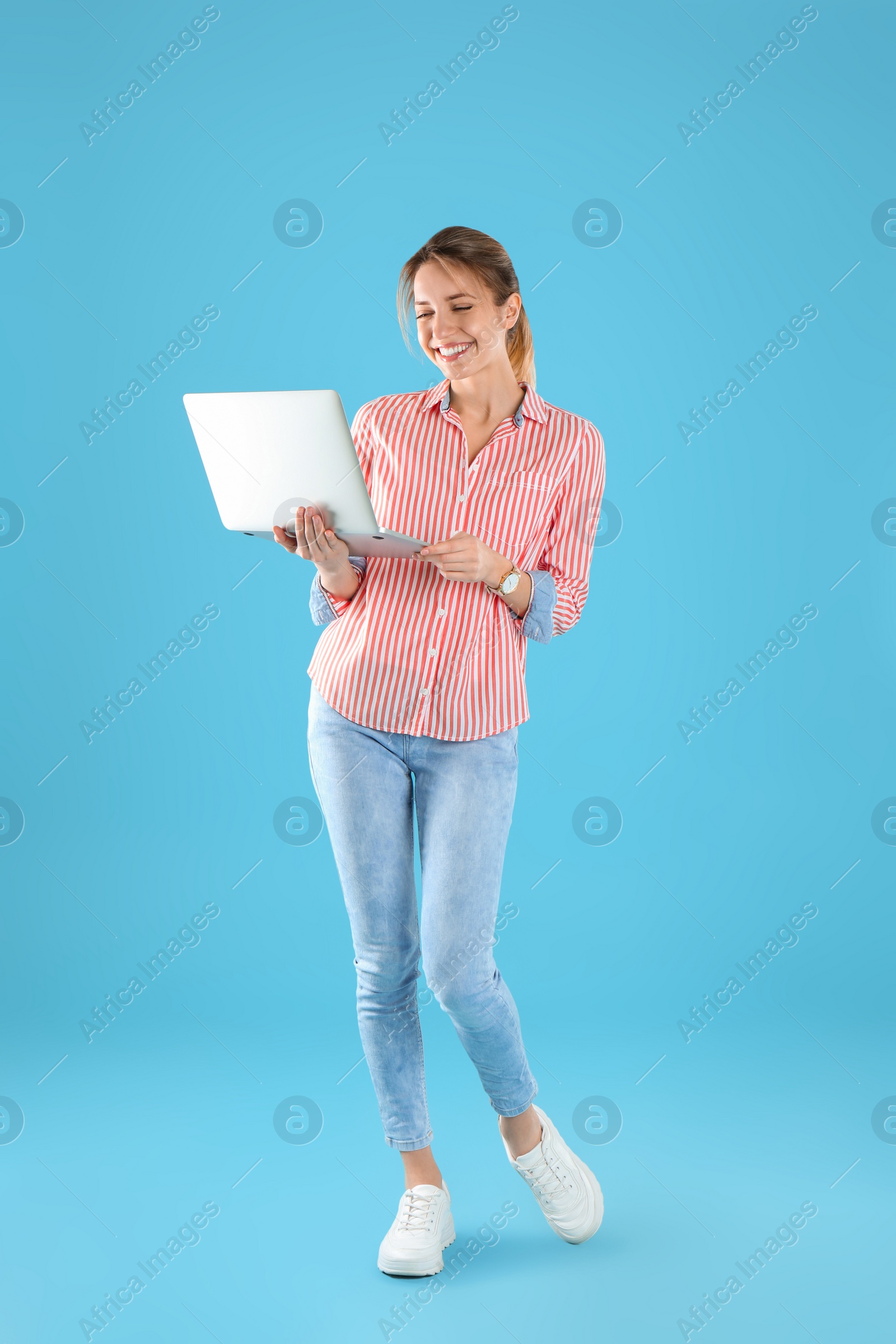 Photo of Full length portrait of young woman in casual outfit with laptop on color background