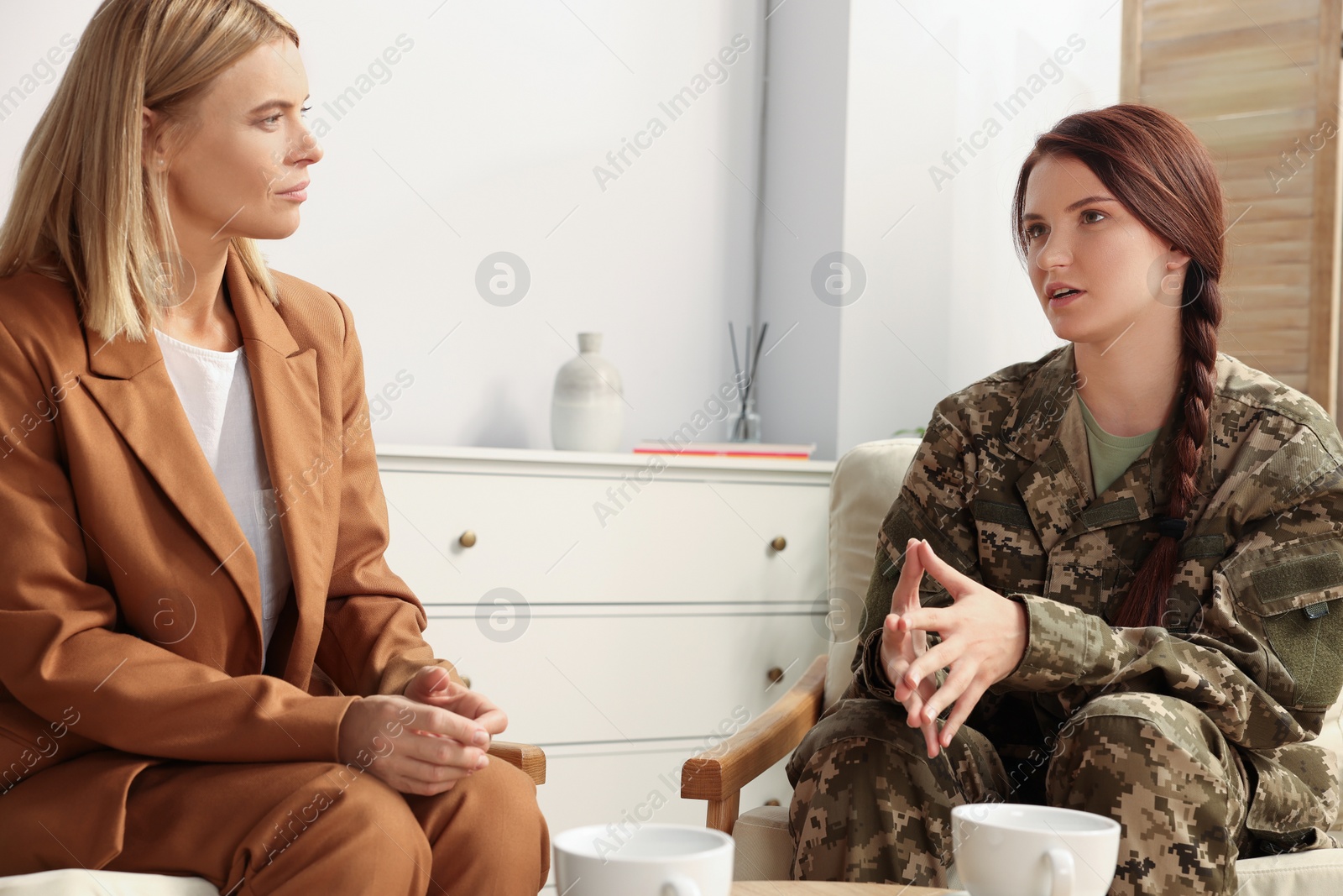 Photo of Psychologist working with female military officer in office