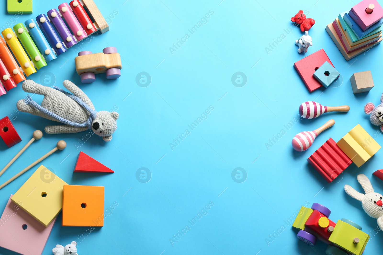 Photo of Flat lay composition with different toys on light blue background. Space for text