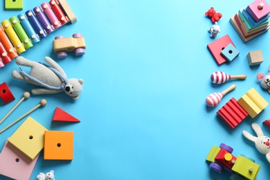 Photo of Flat lay composition with different toys on light blue background. Space for text