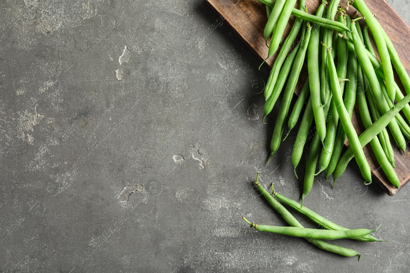 Photo of Fresh green beans on grey table, flat lay. Space for text