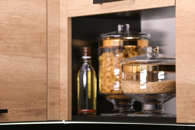 Photo of Shelf with raw cereals in modern kitchen