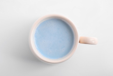 Blue matcha latte in cup on white background, top view