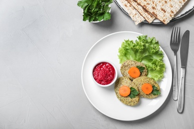 Photo of Flat lay composition with plate of traditional Passover (Pesach) gefilte fish on light background. Space for text