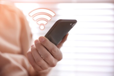 Image of Man using smartphone connected to WiFi indoors, closeup