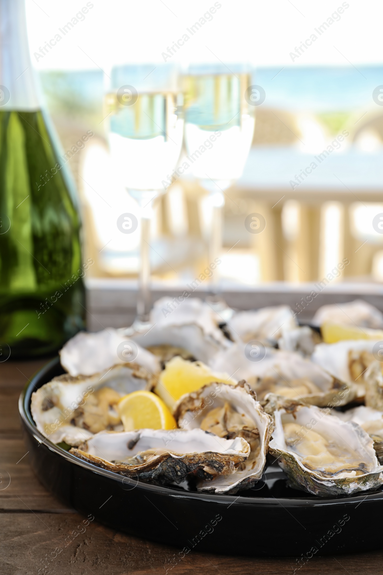 Photo of Fresh oysters with cut juicy lemon served on table