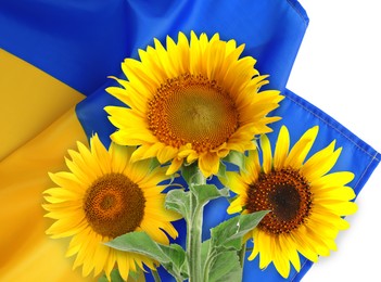 Image of Bright sunflowers and Ukrainian national flag on white background