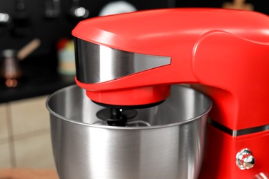 Photo of Modern red stand mixer in kitchen, closeup