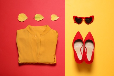 Photo of Flat lay composition with stylish female outfit on color background