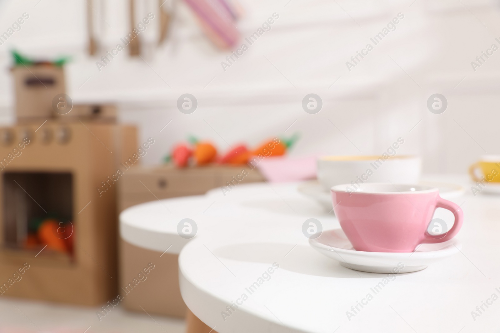 Photo of Cup on white table in kitchen, space for text