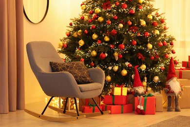 Beautifully wrapped gifts under Christmas tree in room. Festive interior design