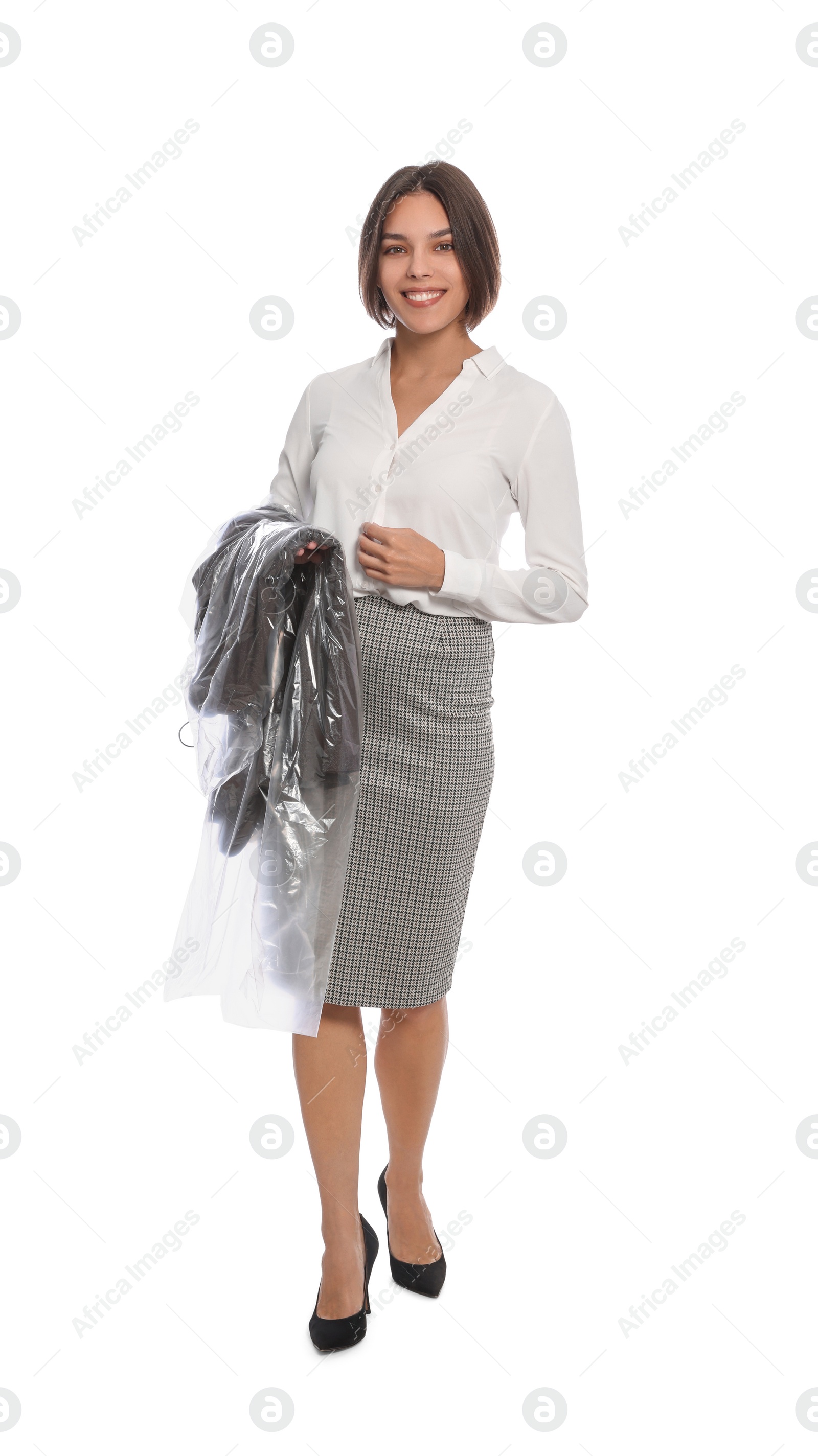 Photo of Woman holding garment cover with clothes on white background. Dry-cleaning service