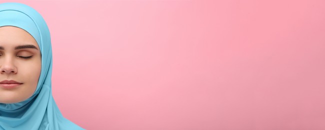 Portrait of Muslim woman in hijab on pink background, space for text. Banner design