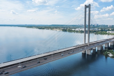 Image of Aerial view of modern bridge over river
