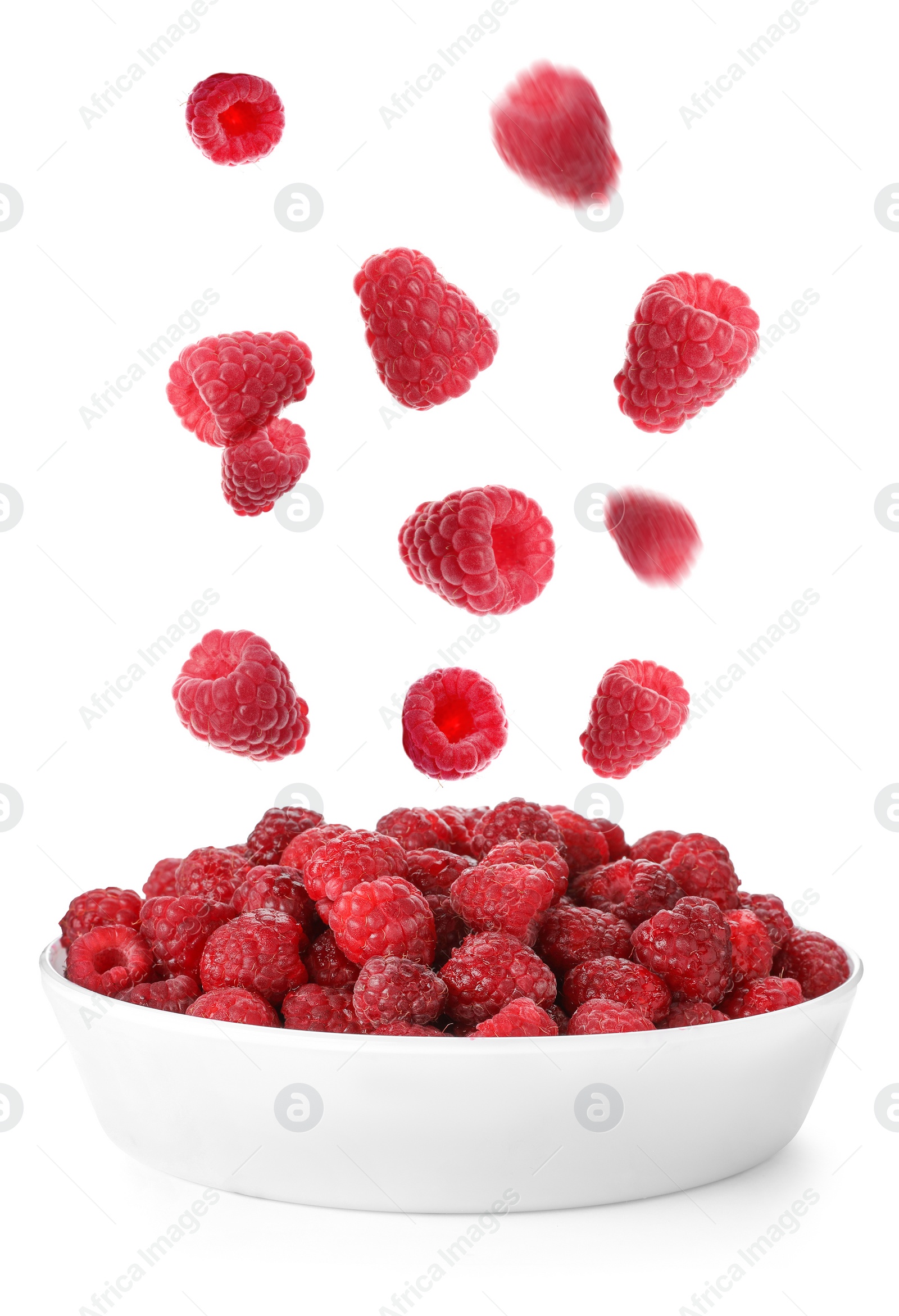 Image of Fresh ripe raspberries falling into bowl on white background