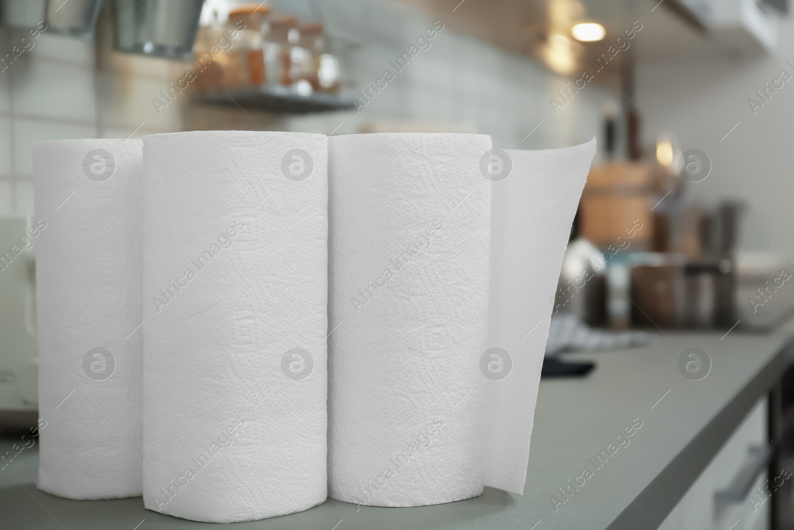 Photo of Rolls of paper towels on table in kitchen, closeup