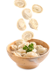 Many tasty dumplings falling into bowl on white background