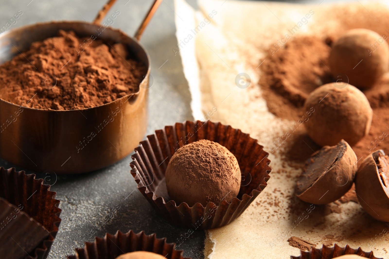 Photo of Composition with chocolate truffles on grey background