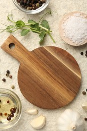 Wooden cutting board and spices on beige table, flat lay. Space for text