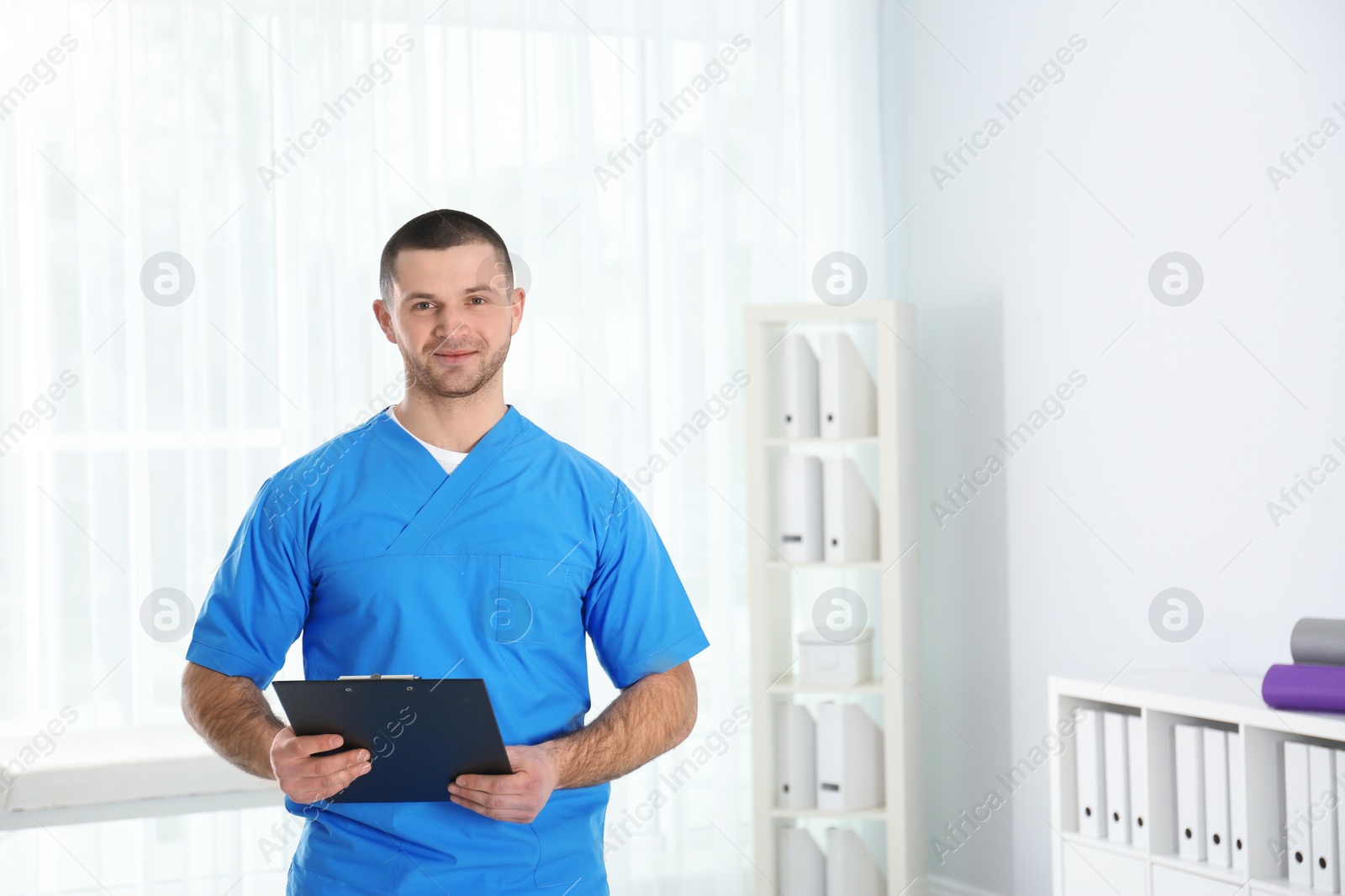 Photo of Portrait of young doctor in hospital, space for text. Rehabilitation physiotherapist
