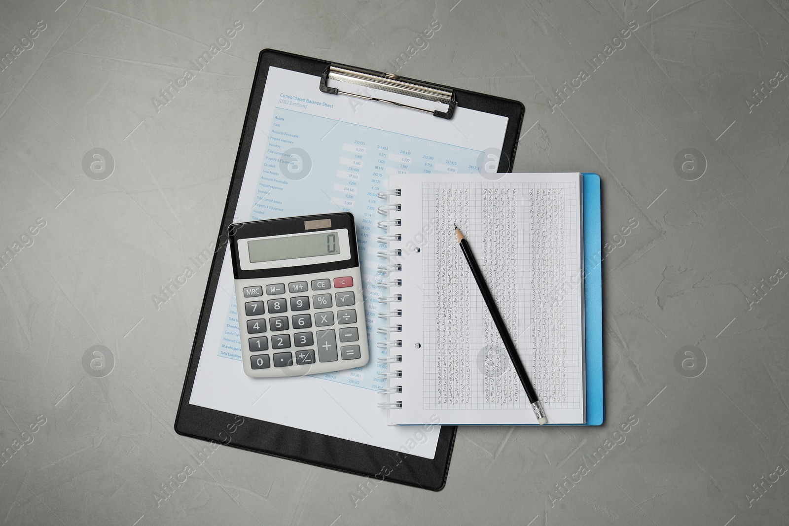 Photo of Calculator, notebook, pencil and document on grey table, flat lay