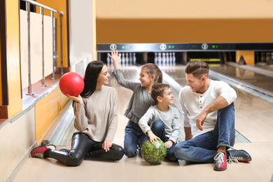 Happy family spending time together in bowling club