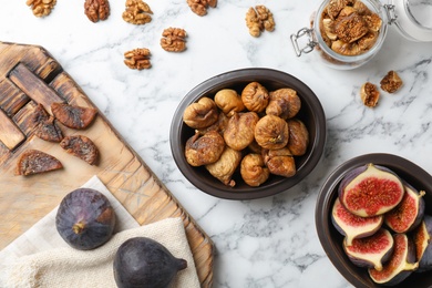 Photo of Flat lay composition with walnuts, fresh and dried figs on marble background