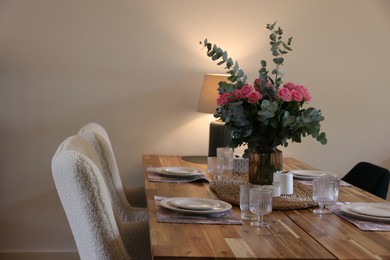 Photo of Beautiful table setting with bouquet and candles in room. Space for text