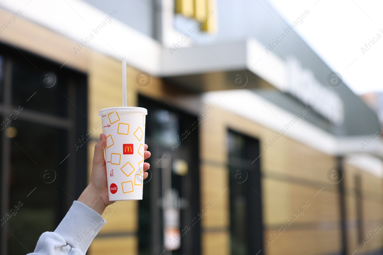 Photo of Lviv, Ukraine - September 26, 2023: Woman with McDonald's drink outdoors, closeup. Space for text