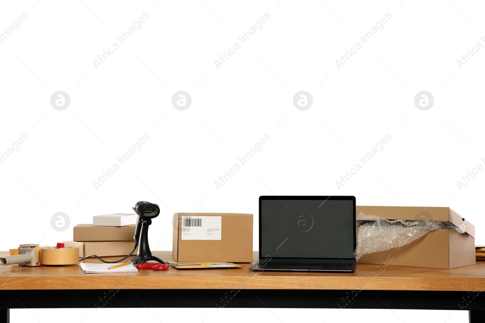 Photo of Parcels, laptop and barcode scanner on wooden table against white background. Online store