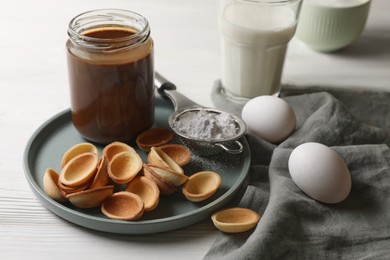 Photo of Ingredients for delicious walnut shaped cookies with condensed milk on white wooden table