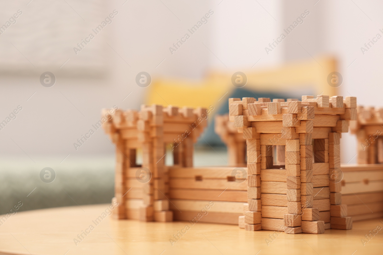 Photo of Wooden fortress on table indoors, space for text. Children's toy
