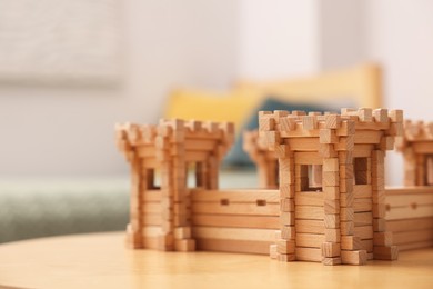 Photo of Wooden fortress on table indoors, space for text. Children's toy