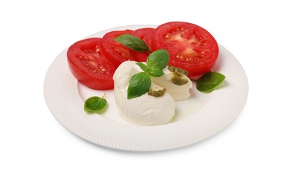 Photo of Plate of tasty Caprese salad with mozzarella, tomatoes, basil and pesto sauce isolated on white