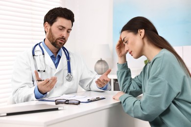 Photo of Doctor consulting patient during appointment in clinic