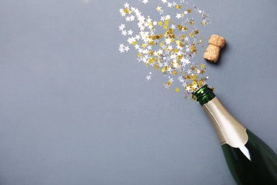 Photo of Creative flat lay composition with bottle of champagne and space for text on color background