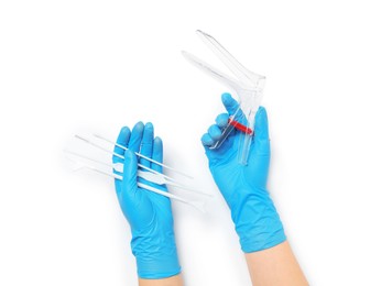Photo of Doctor holding disposable vaginal speculum and gynecological examination kit on white background, top view