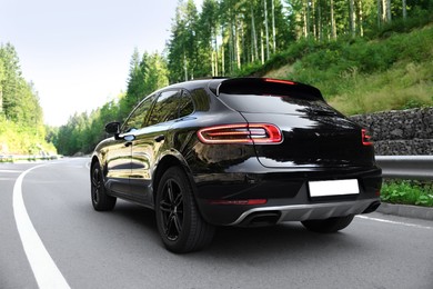 Picturesque view of modern black car on asphalt road outdoors