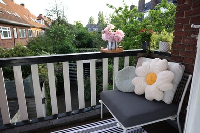 Photo of Different plants on railings and chair at cozy balcony outdoors